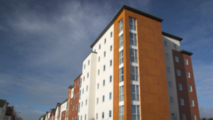 a block of flats with a dark sky behind